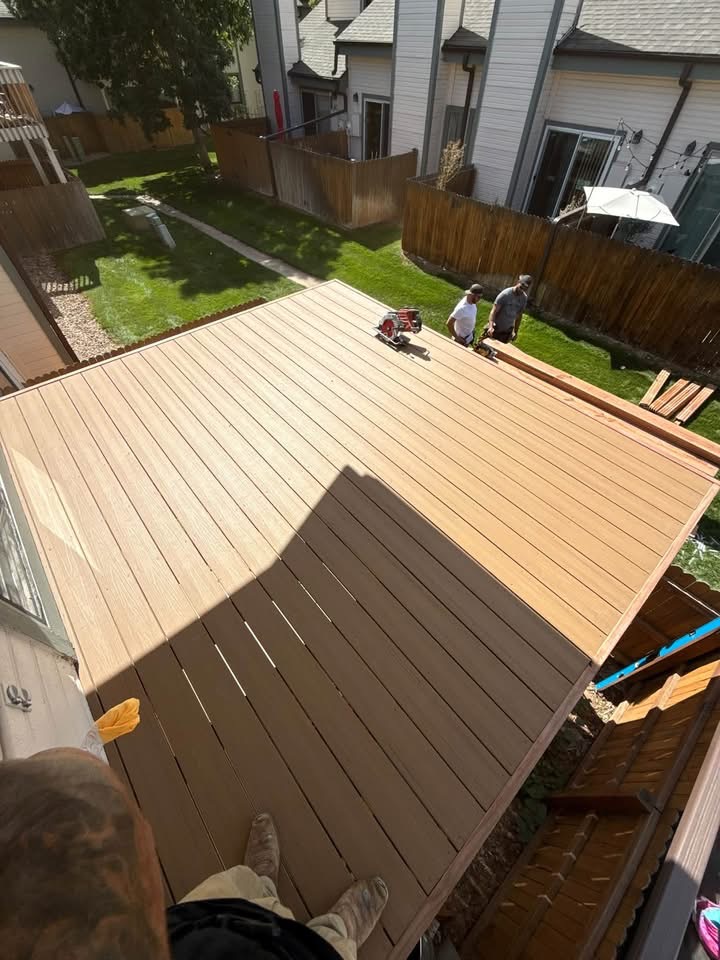 Composite deck boards laid across an elevated deck before the railings go in